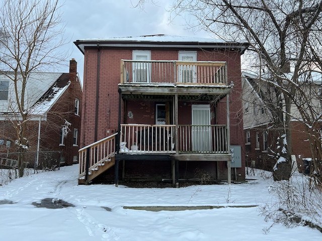 snow covered house with a balcony