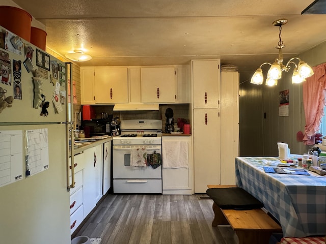 kitchen featuring a notable chandelier, white appliances, dark hardwood / wood-style flooring, hanging light fixtures, and white cabinets