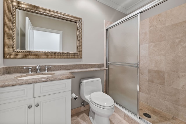 bathroom with toilet, ornamental molding, a shower with shower door, and vanity