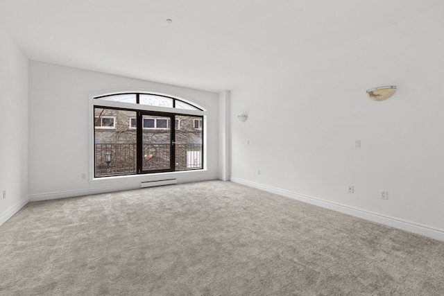 empty room with carpet and a baseboard radiator