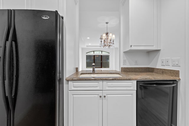 kitchen with black appliances, a chandelier, pendant lighting, white cabinets, and sink