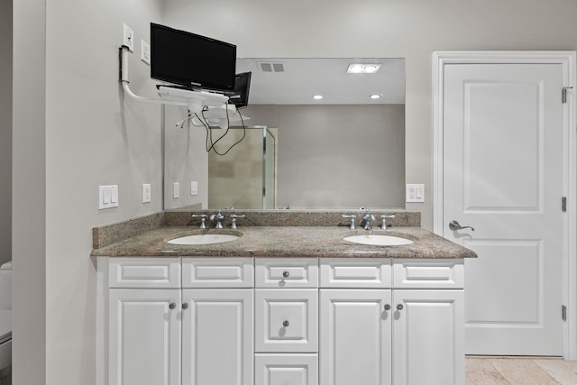 bathroom featuring toilet, tile patterned floors, and vanity