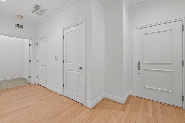 hall featuring light hardwood / wood-style flooring and ornamental molding