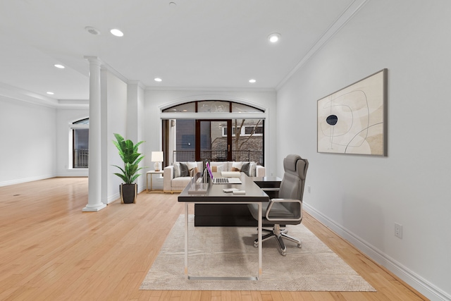 office area with decorative columns, light hardwood / wood-style flooring, and crown molding