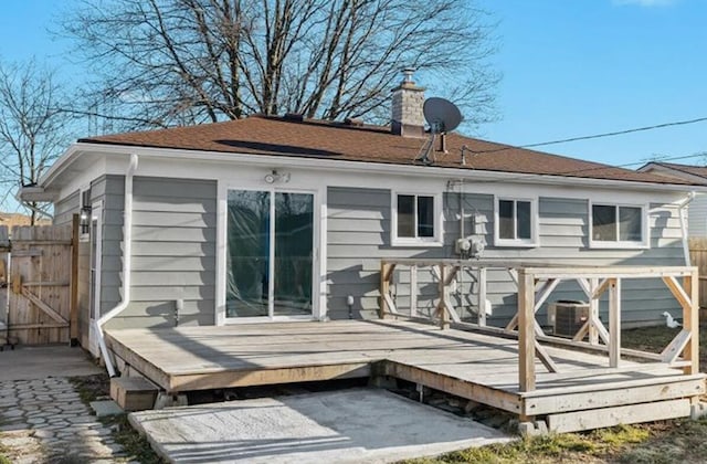 rear view of property featuring a wooden deck and cooling unit