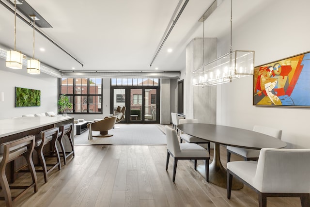 dining room with wood-type flooring and french doors