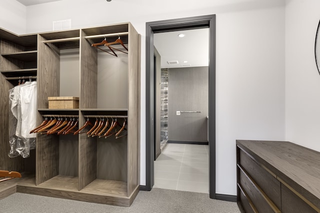 walk in closet with tile patterned flooring