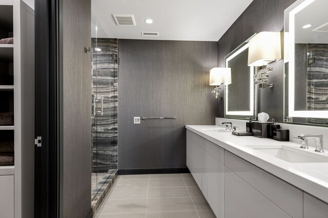 bathroom with walk in shower, tile patterned floors, and vanity