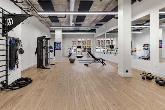 gym with wood-type flooring