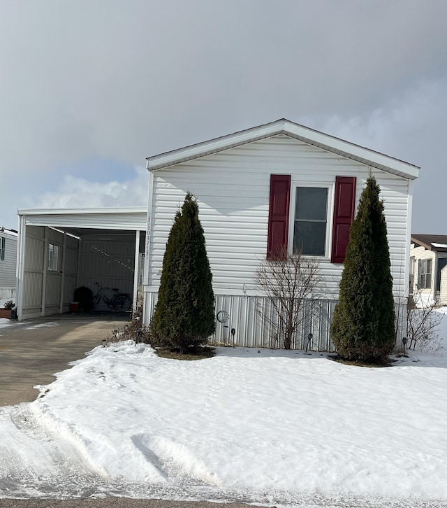 view of snow covered exterior with a garage