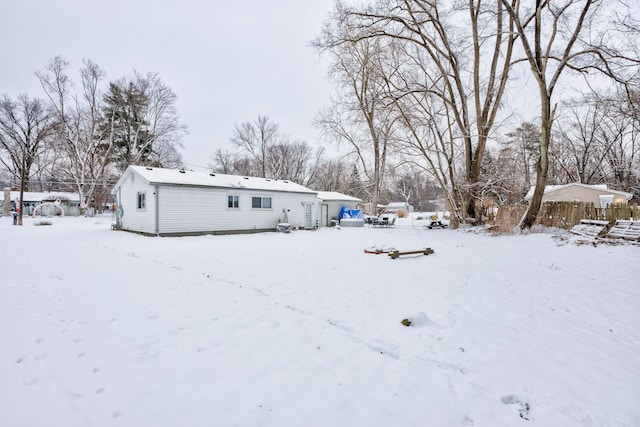 view of snow covered rear of property