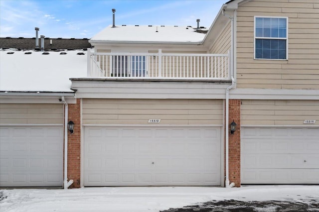 view of front of house featuring a balcony and brick siding