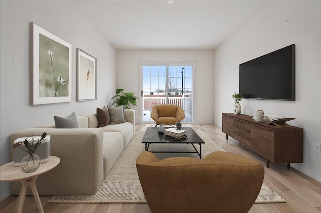 living area with light wood-style floors and baseboards