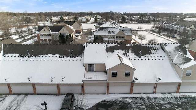 snowy aerial view featuring a residential view