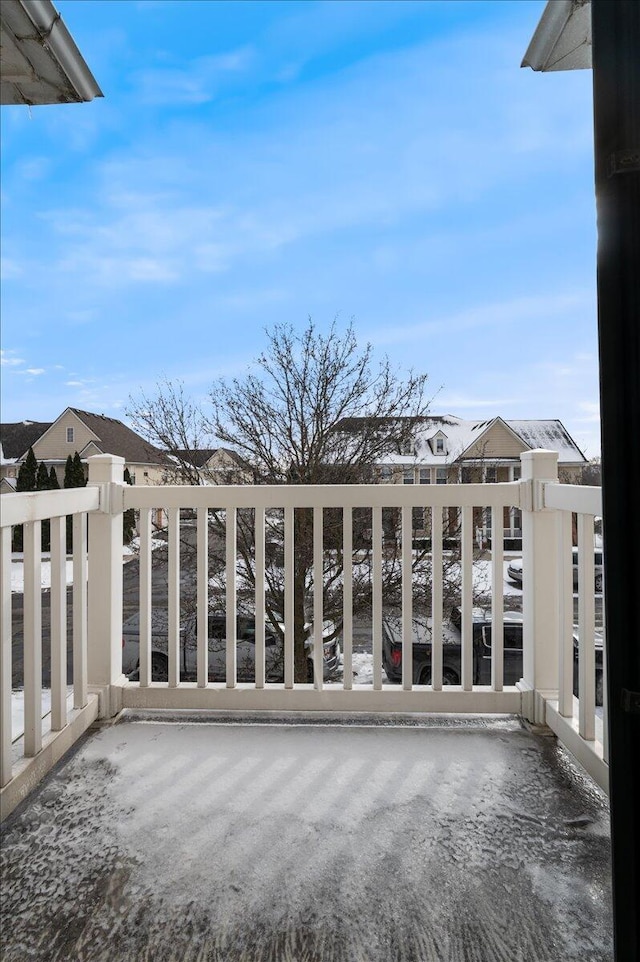 view of snow covered back of property