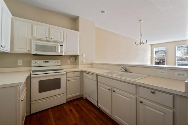 kitchen featuring light countertops, white appliances, white cabinets, and a sink