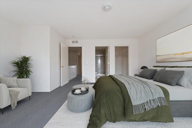 carpeted bedroom with a walk in closet, a closet, visible vents, and baseboards