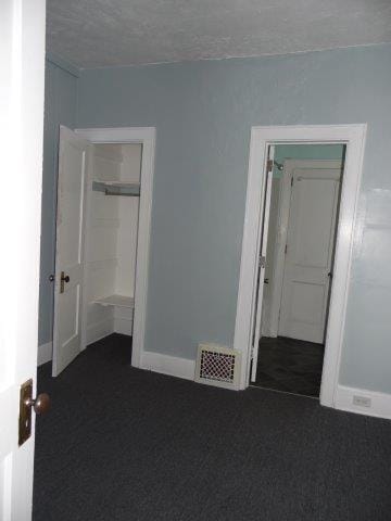 carpeted spare room with a textured ceiling