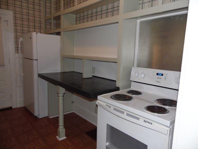 kitchen with white appliances and dark parquet flooring