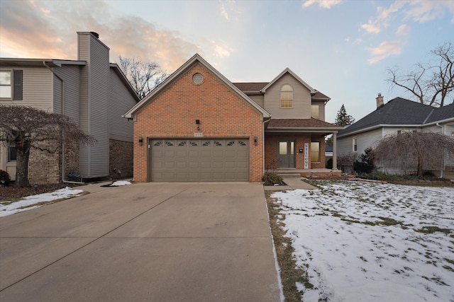 front of property with a garage and covered porch