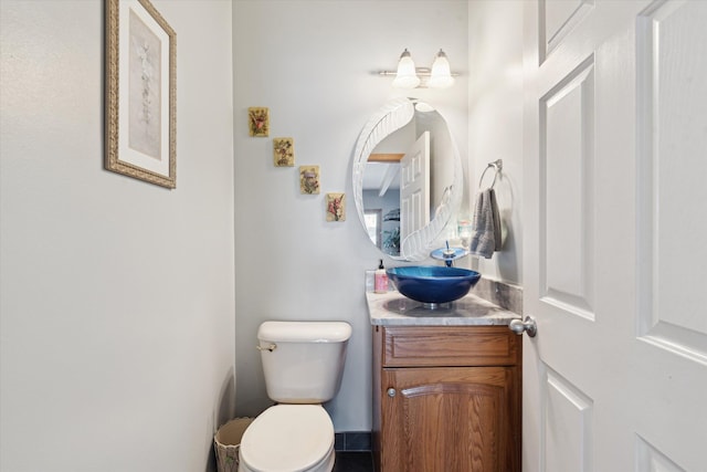 bathroom featuring toilet and vanity