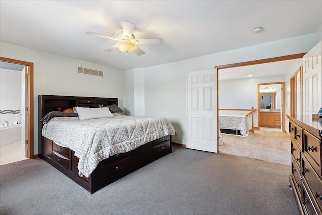 carpeted bedroom featuring ceiling fan and ensuite bathroom