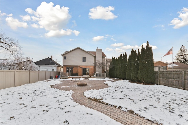 snowy yard with central air condition unit and a fire pit