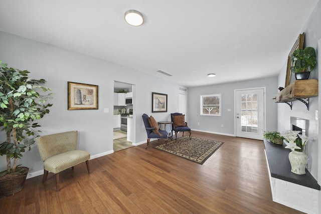 living area with hardwood / wood-style flooring