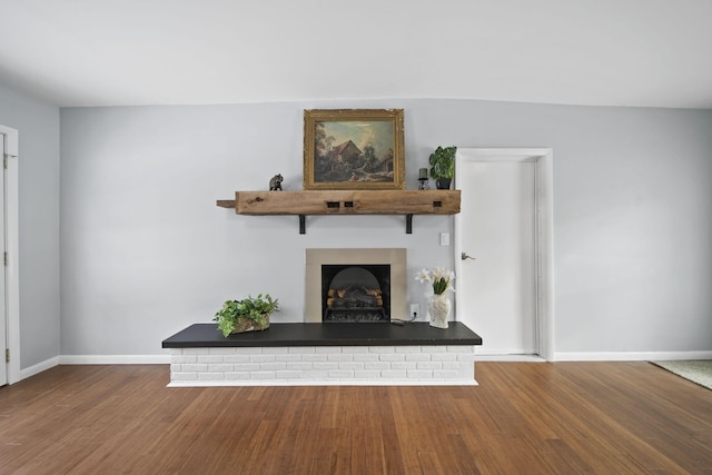 unfurnished living room with wood-type flooring and a fireplace