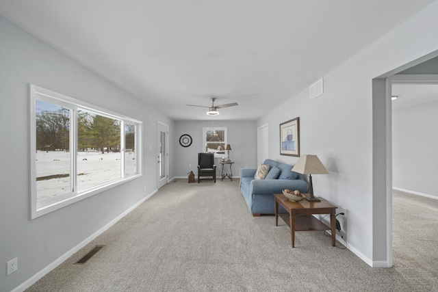 living room featuring ceiling fan and light colored carpet