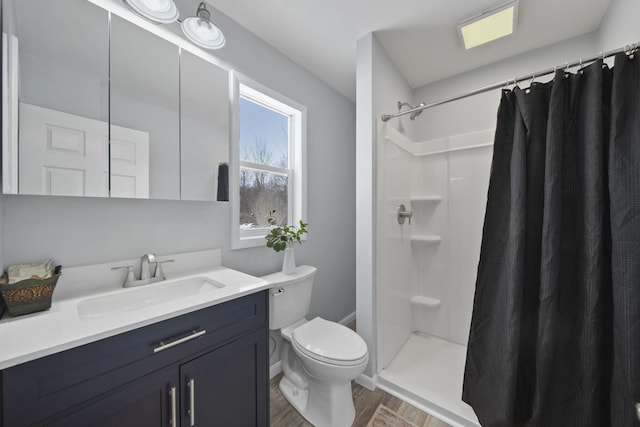 bathroom with toilet, vanity, a shower with shower curtain, and hardwood / wood-style floors