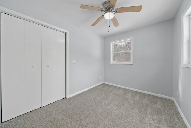 unfurnished bedroom featuring light carpet, ceiling fan, and a closet