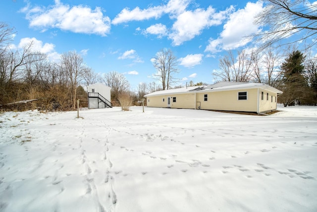 view of snow covered back of property