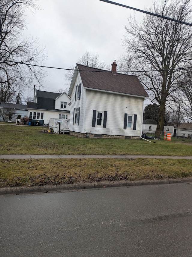 view of side of home with a yard