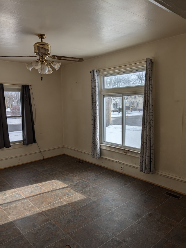 unfurnished room with ceiling fan