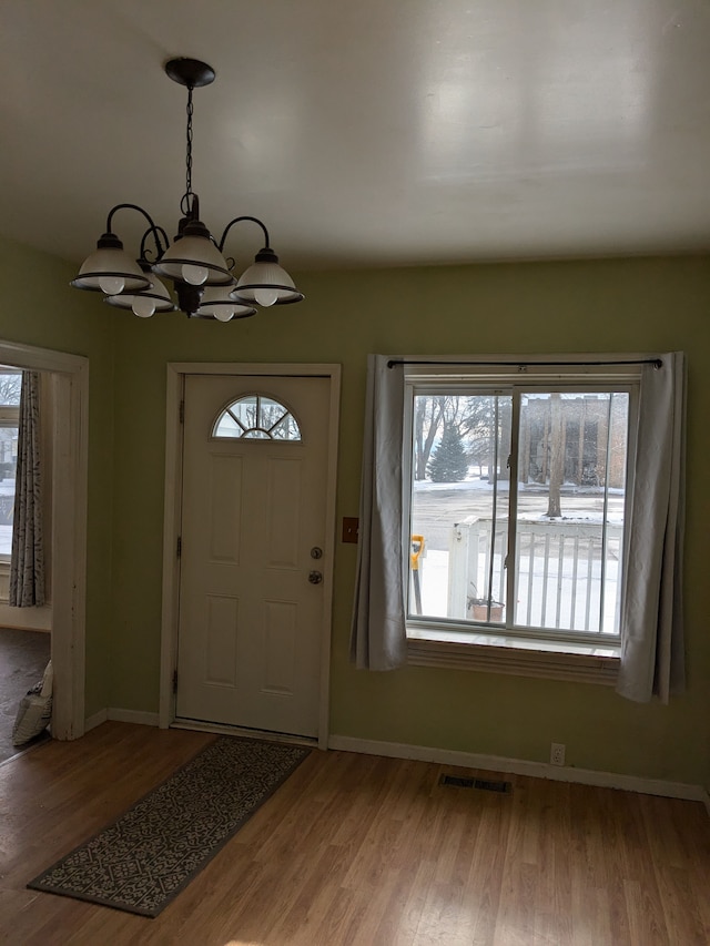 entryway featuring a notable chandelier and hardwood / wood-style flooring