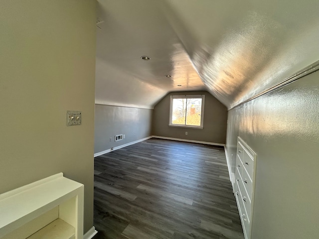 additional living space with dark hardwood / wood-style floors and lofted ceiling