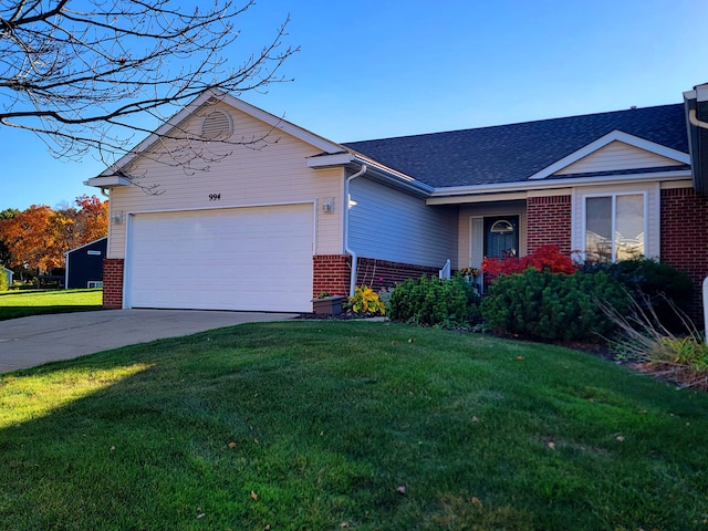 single story home featuring a garage and a front lawn