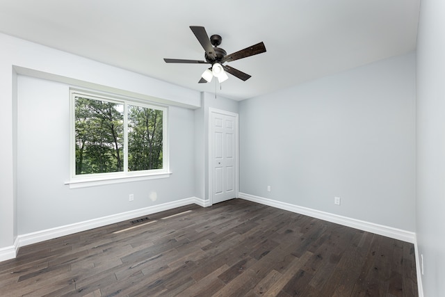 unfurnished room featuring ceiling fan and dark hardwood / wood-style floors