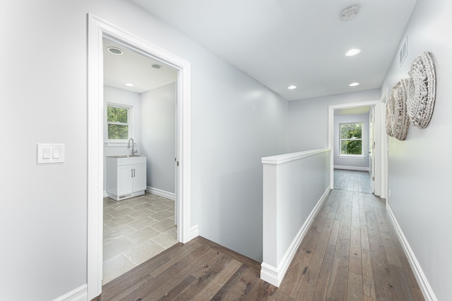 hall featuring sink and hardwood / wood-style flooring