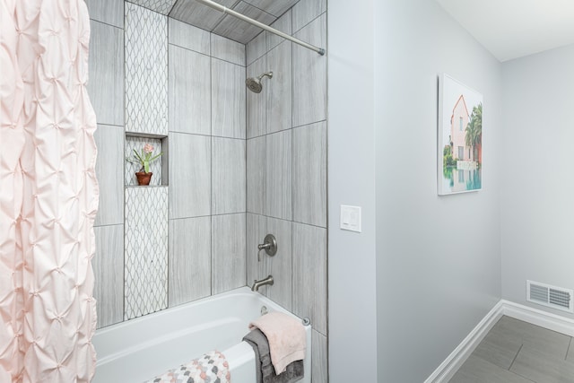 bathroom featuring shower / bath combo and tile patterned flooring