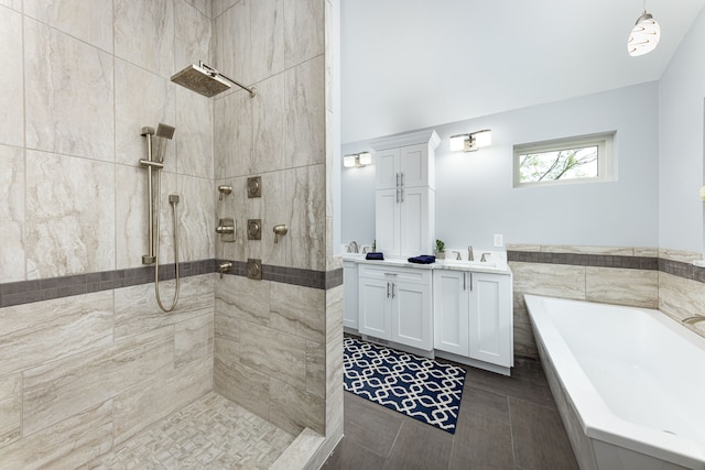 bathroom featuring vanity and independent shower and bath