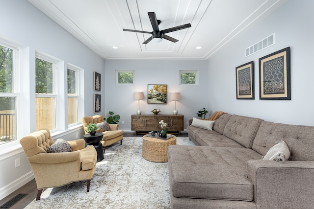 living room featuring ceiling fan, ornamental molding, and wood-type flooring