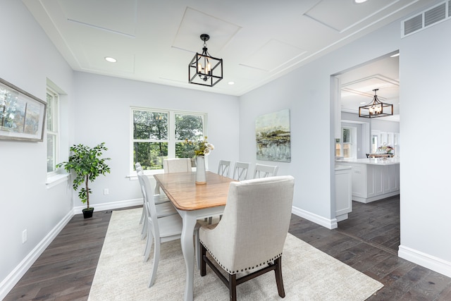 dining room featuring dark hardwood / wood-style flooring and a notable chandelier