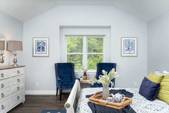 dining area featuring dark wood-type flooring and vaulted ceiling