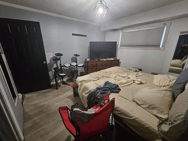 bedroom featuring wood-type flooring and a textured ceiling