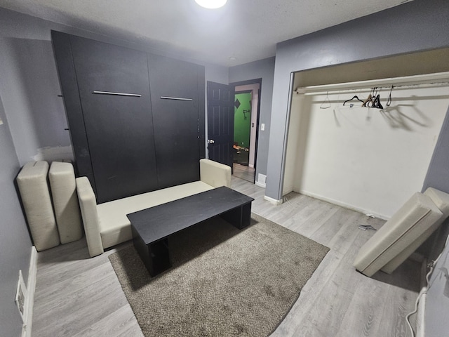 bedroom featuring light wood-type flooring and a closet