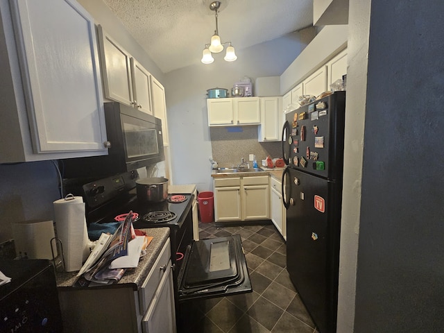 kitchen with decorative light fixtures, white cabinetry, and black appliances