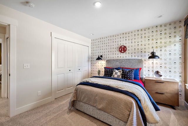 bedroom featuring a closet and light carpet