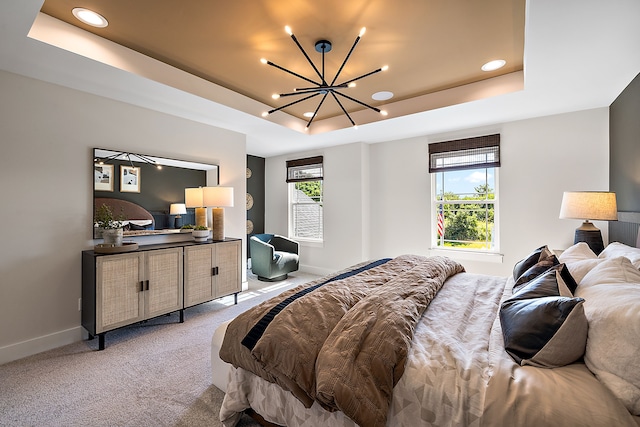 carpeted bedroom featuring a chandelier, a raised ceiling, and multiple windows